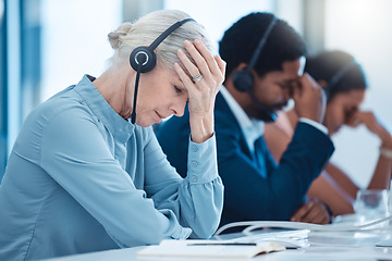 Image showing Telemarketing team, customer service employees and stressed crm workers at office desk. Senior business woman burnout, call center compliance consultant agent and stress headache on call with headset