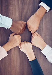 Image showing Fist, above and employees meeting with support, partnership and solidarity together at work. Hands of corporate, diversity and motivation from workers in a team for business and goal on a table