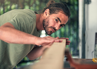 Image showing Carpenter, thinking or checking wood in workshop, small business garage or creative manufacturing factory. Lumber worker, diy man or carpentry designer with furniture, table or desk production ideas