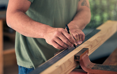 Image showing Man carpenter, measure wood for building and construction project for professional home renovation. Handyman, measuring wooden beam and marking measurements with pen for creating decoration for house