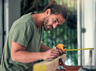 Image showing Carpenter, builder and diy for home improvement, development and repair with concentration in house. Man, wood and measure in home with pencil, measuring tape and focus for renovation of interior.