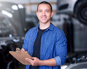Image showing Man, clipboard writing and mechanical engineer in workshop, car manufacturing industry and car garage. Portrait, smile and happy motor production worker with repair schedule or export parts documents