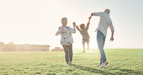 Image showing Love, grandparents and child being playful, happy and bonding on grass, outdoor and together. Grandmother, grandfather and kid enjoy summer holidays, adventure or travel for walking or holding hands