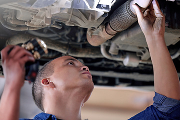 Image showing Car, mechanic in garage and service inspection of motor vehicle for maintenance or safety. Auto shop, automobile workshop engineer and repairman working with torch to check vehicle pipe for oil leak