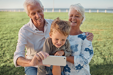 Image showing Happy family, grandparents and child take a selfie in nature with a phone camera for bonding memories outdoors. Smile, old man and elderly woman laughing with an excited young kid on holiday vacation