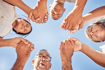 Image showing Worship, prayer and family holding hands praying together for higher power, grace or spiritual help bottom view. Blue sky, christian religion people and bible community hope for Jesus or god support