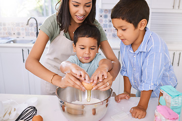 Image showing Mom, kids and kitchen for baking, cooking or cake in home while excited, happy or smile on face. Mother, boy and children in house to crack egg for learning of food, cookies or muffins in Los Angeles