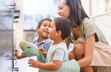 Image showing Family kids bonding, baking and mother happy at a kitchen oven spending quality time. Mama and children smile together with love and care learning to cook at a house with happiness making food