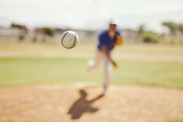Image showing Sports, pitch and baseball ball in air, pitcher throwing it in match, game or practice in outdoor field. Fitness, exercise and training on baseball field with player in action, movement and motion