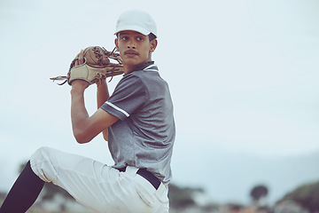 Image showing Man, baseball and pitcher in sports throw or competitive match for point, score or win in the outdoors. Professional baseball player athlete in sport ready to pitch the ball on the field outside
