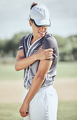 Image showing Baseball player, arm injury and pain during sports training, fitness exercise and athlete practice outdoor on field. Injured man massage muscle area for fibromyalgia, orthopedic or softball accident