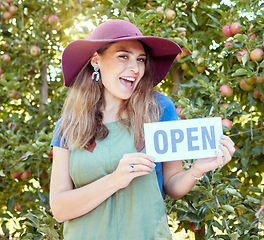 Image showing Woman, fruit farm and open store sign of a happy entrepreneur for agriculture and apple orchard. Female manager proud and success smile with sustainable, eco friendly ecology and green farming trees