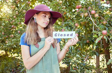 Image showing Woman farmer, closed sign and apple farm, agriculture worker and sustainability business. Farming employee with icon or board for advertising end of fruit garden collection season or work day outdoor
