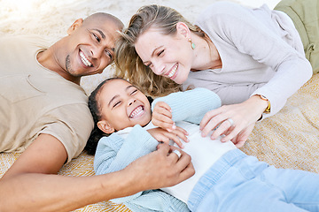 Image showing Happy, mother and father with kid lying on the beach in playful happiness laughing in family bonding in the outdoors. Mama, dad and child playing in the sand together with smile for relationship