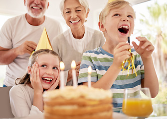 Image showing Happy birthday, family and girl with a cake in a party celebration with grandparents and excited sibling or brother. Smile, happiness and young child celebrates, laughing and enjoying a special day