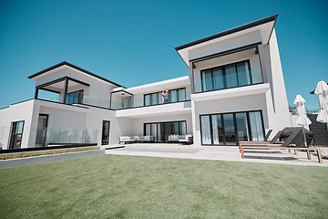 Image showing House, property and elderly couple on a balcony, relax and bonding at their dream home. Real estate, family house and retirement by senior man and woman standing, hug and talking on a terrace