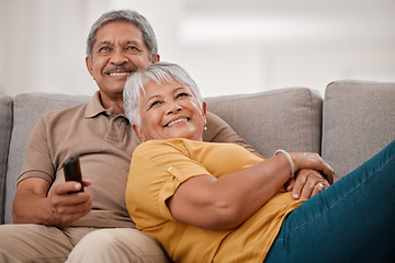 Image showing Happy senior couple, love and watching tv relax together on living room sofa at family home. Elderly married man and woman, chill and watch television on couch bonding, laughing and smile at movie