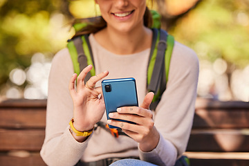 Image showing Phone, hands and hiking woman relax outdoors check hike trail online using 5g tech internet device. Young girl smile, search travel direction or type social media smartphone communication in nature