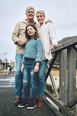 Image showing Portrait, child and grandparents on a bridge in a park for adventure, walking and happiness together. Happy, smile and young girl with senior and elderly people on family walk in nature during winter