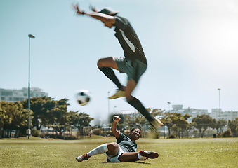 Image showing Football player, soccer ball and field sport for fitness training, workout and game for sports competition. Athlete woman and man jump to kick ball for tackle, exercise and cardio health on grass