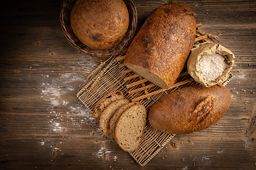 Image showing Fresh bread on wooden background