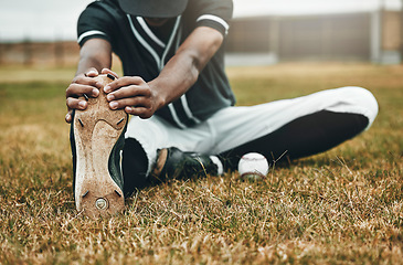 Image showing Baseball, player and stretching for game, training and workout on field, with ball and sportswear for health. Black man, athlete or doing exercise to prepare for game, match or fitness being healthy