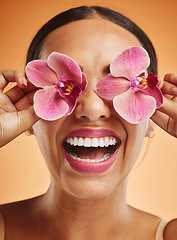 Image showing Skincare, beauty and flowers on face of woman for spa wellness, health and beauty products. Creative, facial and happy girl with orchid over eyes for natural cosmetics, makeup and skincare products