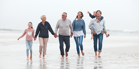 Image showing Family, beach and children with grandparents, parents and kids walking in the water on the sand in a summer holiday. Travel, love and vacation with a girl, boy and relatives taking a walk by the sea