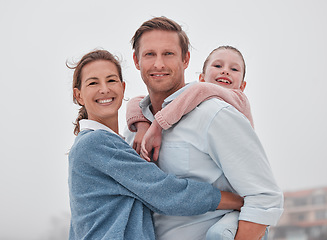 Image showing Family, hug and outdoor, love and smile, together in nature and bonding in travel portrait. Parents, child and happy, hugging and piggy back, father with mother and girl, spending quality time.