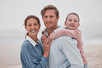 Image showing Happy family, mother and father with child at a beach enjoying winter holiday vacation and bonding outdoors. Smile, mom and girl hugging dad, relaxing and spending quality time at an ocean in Sydney