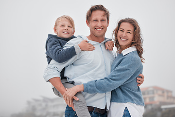 Image showing Family, children and beach with a boy and parents by the sea or ocean for a holiday on a misty day. Portrait of kid, love and nature with a mother, father and daughter by the water during autumn