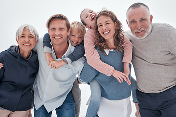 Image showing Happy big family, portrait and piggy back on holiday, vacation or trip against cloudy sky. Love, care and man, woman and children with grandparents bonding outdoors together in misty winter weather.