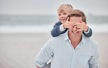 Image showing Father, boy and piggy back beach, vacation or summer holiday outdoor. Love, family and dad, kid walking and bonding together spending time on ocean, sea or sandy shore in support, care and piggy back