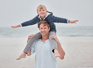 Image showing Child, dad and piggy back on beach on a family holiday ocean walk in Australia. Travel, fun and a portrait of happy father and son with smile playing on sea sand on vacation with open sky and waves.