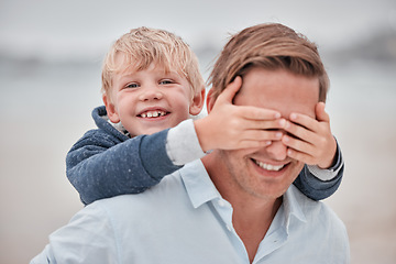 Image showing Family, face and father and son at a beach with hands covering dad eyes for surprise, guess and game. Travel, happy family and child hand on man eye while walking, laughing and bonding on ocean trip