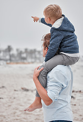 Image showing Travel, family and father with son at a beach, having fun while carrying child on shoulders and enjoying the view in Mexico. Parent, kid and hand of boy pointing to cloudy sky while on a sea vacation