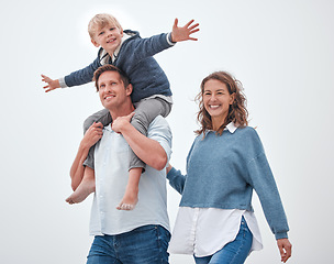 Image showing Dad, boy and shoulders for walk, family and smile together outdoor in sunshine with happiness. Father, mother and child in summer, happy and walking for bonding, relax and love on vacation in Madrid