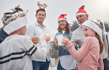 Image showing Family, christmas and hat for toast with cup, smile and celebration with happiness, together and outdoor. Group, mug and happy for holiday, festive and eggnog for religion, event or party with coco