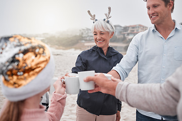 Image showing Family, Christmas and holiday celebration on beach with drinks, smile and cheers. Happy man, senior woman and child celebrate spending time together on December ocean vacation drinking hot chocolate.