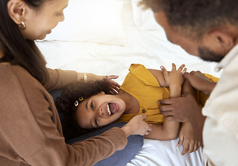 Image showing Family tickle, playing and girl with happy parents bonding with quality time together at a home. Laughing, smiling and happiness of a child smile with a mom, father and care on a bedroom bed