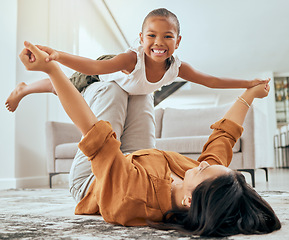 Image showing Mother lift girl on floor and play in home living room for family love, care and wellness. Happy kid play fun youth game with mom and bond in house lounge with smile, happiness or relationship
