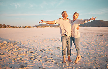 Image showing Love, beach and summer with a senior couple standing together on the sand on a sunny day. Travel, vacation and romance with a n elderly man and woman pensioner enjoying their retirement in nature