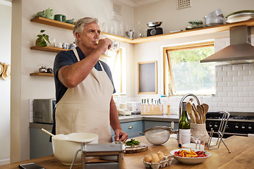 Image showing Senior man, drink wine in kitchen and relax after cooking food for a healthy meal for lunch at home, happy and enjoying retirement. Elderly, retired person and baking while drinking alcohol in glass