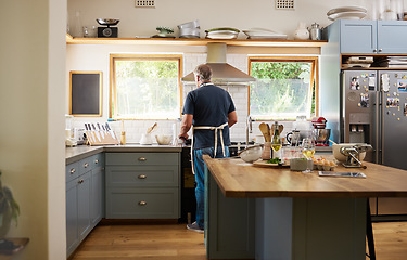Image showing Cooking, breakfast and man in the kitchen of a house for healthy food, diet and lunch. Back of a mature and hungry chef in retirement with dinner, baking or easy meal in a home in the morning