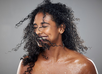 Image showing Healthy, wet hair and skincare beauty of a black woman with cosmetics product mockup to hydrate, nourish and moisturize African hair. Clean skin health, cosmetics treatment and gray studio background