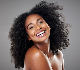 Image showing Black woman, smile and hair for face, makeup and happy with beauty, afro and cosmetics in studio portrait. Model, happiness or skincare with cosmetic, shine or glow for healthy, hair care or wellness