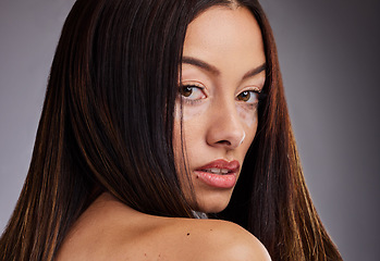 Image showing Beauty, vitiligo and portrait of a woman with a skincare treatment for wellness, health and cosmetics. Natural face, piebald skin and model from Mexico isolated in a studio with a gray background.