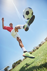 Image showing Football, fitness and soccer player training with a juggling exercise on soccer field, grass or football stadium. Sports, jumping and below view of a healthy athlete with skills and creative talent