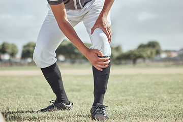 Image showing Baseball leg injury, man and sports athlete on a outdoor grass field hurt in the summer. Baseball player experience a muscle pain from workout exercise, fitness and cardio game training accident