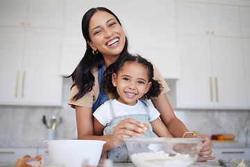 Image showing Mother, baking and bonding of a girl with mama learning in a home kitchen with a smile. Portrait of a happy black mom with cooking, love and care holding her kid in a house together smiling